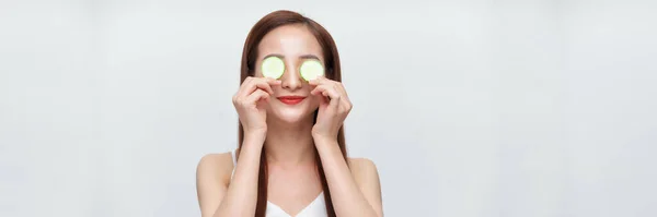 Banner of asian woman with cucumber slices on her eyes