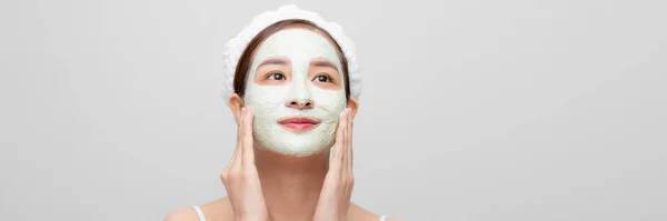 beauty asian woman getting facial mask on web banner