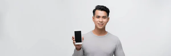 Χαμογελώντας Νεαρός Άνδρας Κρατά Ένα Σύγχρονο Smartphone Στο Χέρι Του — Φωτογραφία Αρχείου