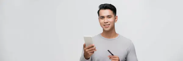 Young Asian Man Holds Credit Card Smartphone Isolated White Background — Stock Photo, Image