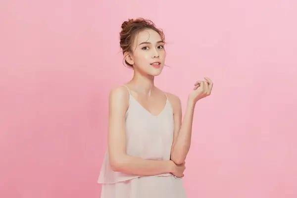 Young Asian beauty woman with korean makeup on face and perfect skin on isolated pink background.