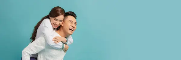 stock image Happy smiling couple in love. Over blue background