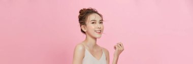  Portrait of attractive asian girl with beauty natural skin isolated on pink background