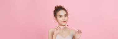 Photo of shirtless woman posing with lipstick, isolated studio background.