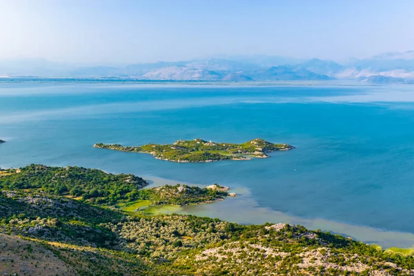 stock image Shtegvashe Viewpoint. Beautiful summer landscape of small green islands and blue waters of Lake Skadar near the border with Albania. Clear blue sky. Montenegro. Travel concept.