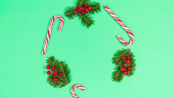 Frame Candy Canes Spruce Branches Decorated Red Berries Green Background — Stock Video