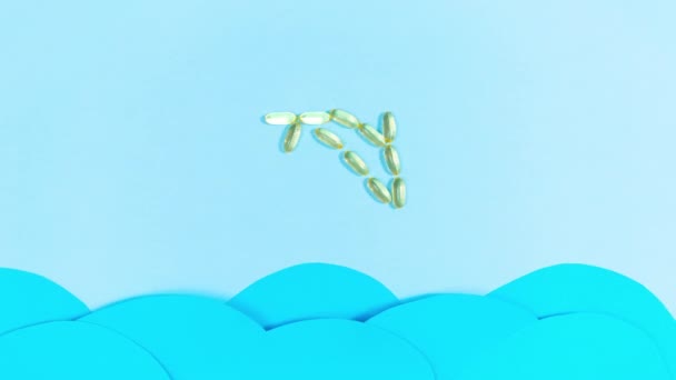 オメガ3と黄色の透明なカプセルから作られた魚は 青い波を移動上記の海から飛び出します 健康の維持と改善 ストップモーションアニメーション — ストック動画