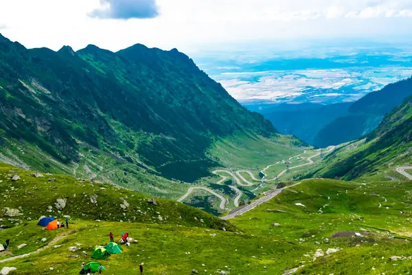 stock image Beautiful landscape of high green mountains and turns of Transfagarasan road, is one of the most beautiful roads in the world. Carpathians. Romania.