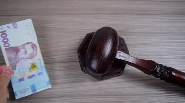 Hakimin törensel ahşap tokmağının yanına el, Ukrayna 'nın binde birlik banknotlarından oluşan bir yığın yerleştirir. Yolsuzluk, rüşvet ve yargı sisteminin satışı dışında.