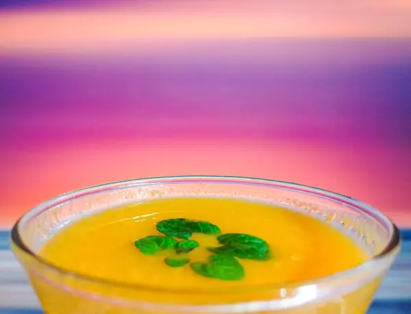 Orange Juice in Bar Glass in front of blurry blinking lights background