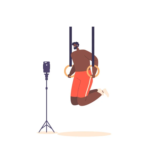 ジムで体操リングをプッシュアップし ワークアウトプロセスのビデオチュートリアルを記録する若い男 アフリカ系アメリカ人アスリート男性キャラクターカリステニクストレーニング 漫画人ベクトルイラスト — ストックベクタ