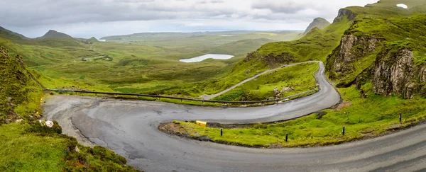 stock image Mountain road for traffic visiting the Quiraing walking trail,amongst beautiful dramatic scenery,winding down to the coast,on a rainy mid summer day.north east of Skye.