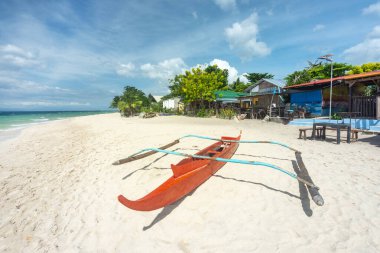Moalboal,Cebu Island,Philippines-January 20th 2023-As post-Covid travelers slowly return to the tropical Asian beaches,here in the Philippines,a calm relaxed vibe exists on the idyllic white sands.