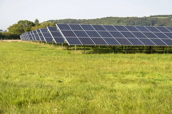 Solar energy production,at a site in the countryside, during the summertime in rural England,providing clean sustainable energy to local areas and villages,around the Gloucester area.