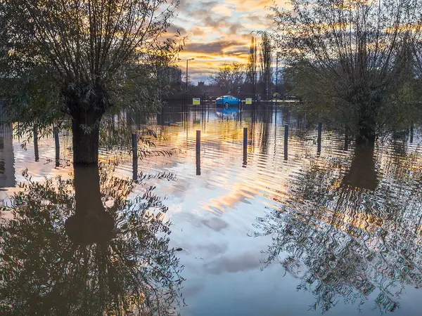 Extreme weather conditions,extensive flooding,after heavy,prolonged rain and storms,high,overwhelming river water levels,swans swim in previously dry areas,roads cut off,flooded properties and roads.