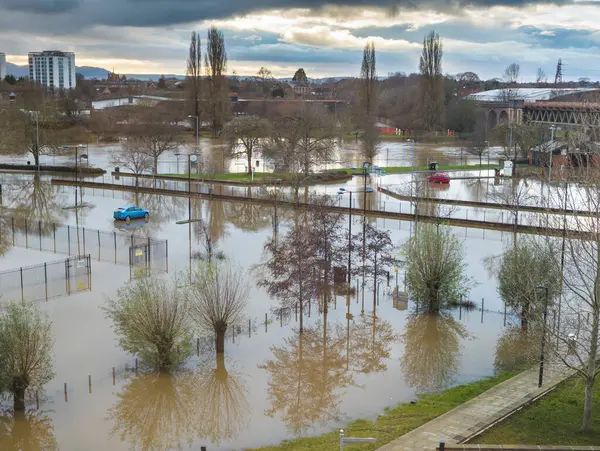 Extreme weather conditions,extensive flooding,after heavy,prolonged rain and storms,high,overwhelming river water levels,engulfing fields and properties,cutting off flooded roads.