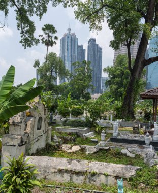 Kuala Lumpur, Malezya-16 Nisan 2023: Jln Ampang açıklarında kıstırılmış ve Kampung Baru 'dan karayolu ile ayrılmış KL' nin en eski Müslüman mezarlıklarından biridir. Dev sancaklar ve yağmur ağaçları tarafından gölgeleniyor..