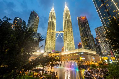 Kuala Lumpur,Malaysia-April 23 2024: As the evening approaches within KLCC Park,at the esplanade outside of Suria KLCC Mall,many visitors anticipate the upcoming colorful musical fountains display. clipart