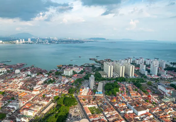 stock image Stunning views of the city and Malacca Strait, from the rooftop and Skywalk of George Town's tallest building and prominent landmark,with mainland Malaysia in the background,as sunset approaches.