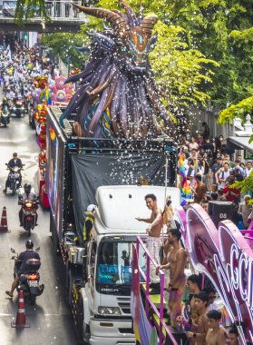 Bangkok,Thailand - June 30 2024:Thousands of people from the LGBTQ community parade on buses,motorbikes,classic cars and by foot,celebrating love, gay marriage,equality,peace and sexual tolerance. clipart