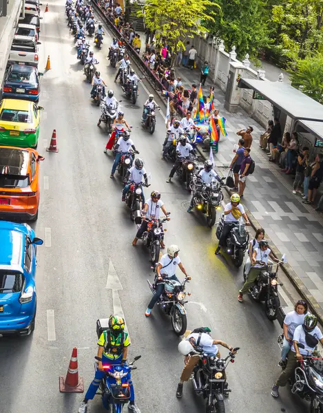 stock image Bangkok,Thailand - June 30 2024:Thousands of people from the LGBTQ community parade on buses,motorbikes,classic cars and by foot,celebrating love, gay marriage,equality,peace and sexual tolerance.