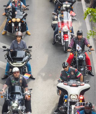 Bangkok,Thailand - June 30 2024:Many gay male motorcyclists, from the BKK LGBTQIA community line up, before cruising past crowds of people lining the streets,celebrating tolerance and diversity. clipart