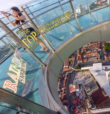 Penang Island,Malaysia-April 26 2023:Atop George Town's tallest building,the transparent Skywalk,extended outward from level 68,is popular with tourists,but not recommended for vertigo sufferers. clipart