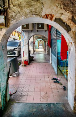 Georgetown,Penang,Malaysia-April 27 2023: The covered colonial arches lining the buildings' exteriors,offer shade to the sidewalks of the beautiful old steets of the city,a UNESCO Heritage site. clipart