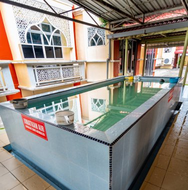 Langkawi Island,Malaysia-May 02 2023:A dedicated area for ritual washing and symbolic purification, within the interior of the Mosque,used before praying in the main hall. clipart