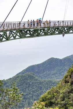 Langkawi,Malaysia-May 03 2023:Winding high over the peaks of Mat Cincang mountain,the cable stayed bridge is a major tourist site with awesome views across the islands,1270 ft above sea level. clipart