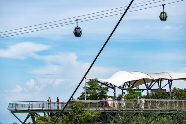 stock image Langkawi Island,Malaysia-May 02 2023:Perched on the peaks of Mat Cincang,second highest mountain on the island,the Sky Cab,a gondola lift and major tourist attraction,runs above sightseeing tourists.