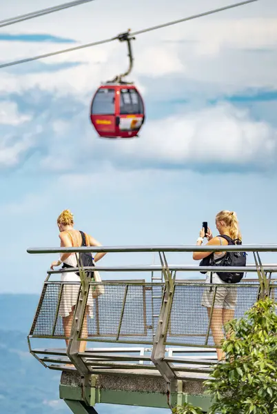 stock image Langkawi Island,Malaysia-May 02 2023:Perched on the peaks of Mat Cincang,second highest mountain on the island,the Sky Cab,a gondola lift and major tourist attraction,runs above sightseeing tourists.