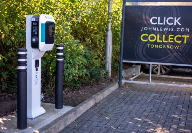 Worcester,England,UK-September 17 2024:An EV charge point,standing outside,ready to use, at a public electric vehicle charging location,within a supermarket car park.