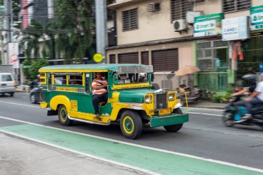 Manila,Philippines-January 13 2023:The colorful,rustic vehicles rush around the streets,symbolic of Philippine culture and art,the most popular and crowded form of public transport in the country. clipart