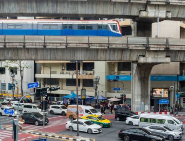 Tayland-Temmuz 03: 2024: Bir BTS Skytrain, Ratchadamri Yolu üzerinde, araçlar ve yayalar Bangkok şehir merkezinde ilerlerken,.