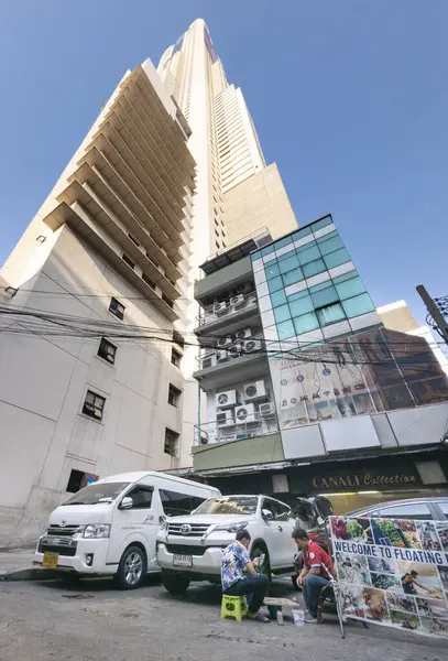 Bangkok, Tayland-07 Nisan 2024 Aşağıdaki sokaklardan yukarıya, 88 katlı bina güneş ışığına doğru yükseliyor ve yukarıdaki açık mavi gökyüzü büyük bir şehir simgesi haline geliyor..