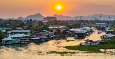 Near to the famous Bridge Over The River Kwai,with great views over the town and along the river,with floating huts and cafes,with small boats drifting across reflections of sundown on the water.
