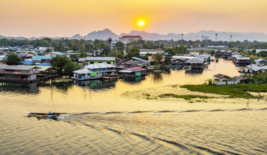 Near to the famous Bridge Over The River Kwai,with great views over the town and along the river,with floating huts and cafes,with small boats drifting across reflections of sundown on the water.
