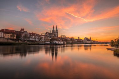 Günbatımında Tuna nehri, katedral ve taş köprü ile Regensburg, Almanya 'da altın saat