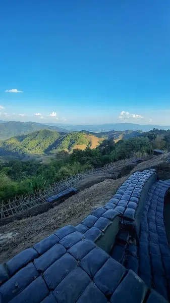 Landscape from the border military base atop a high mountain. There are black sandbags lined up. of Burma A viewpoint in a military base that allows the general public to travel in Thailand.