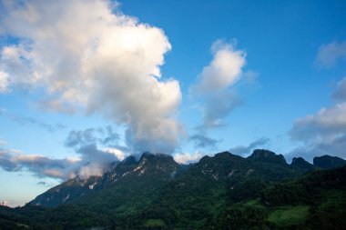 Tepesinde bulutlar yüzen güzel yüksek dağ manzarası. Tayland 'daki yeşil dağlar, açık gökyüzü.
