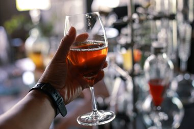 Elimizdeki temiz bardaktaki seçici Focus Şarabı. Deneysel olarak bizim ürettiğimiz bir içecek dükkanında. Taze şarap.