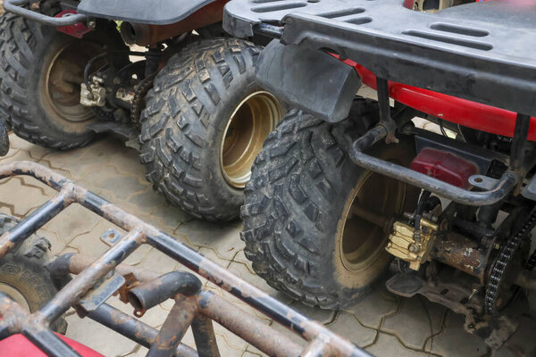 Excited group of friends ready for an adventurous ride on rugged all terrain vehicles, embracing outdoor exploration and thrilling off road experiences with anticipation and joy