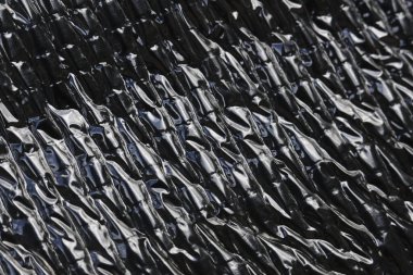 Abstract texture background with crumpled pattern on black and silver metal foil surface. modern, industrial material for design and detail with rough feeling