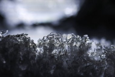 Sparkling ice crystal reveals fascinating frozen texture, reflecting intense cold of winter macro environment. Captivating close up captures sharp and brilliant details of icy surface