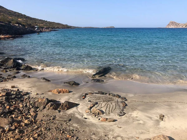 A small hidden little Kolokytha beach in Crete, Greece. Paradise for holidays. Rocks forming a heart on the beach