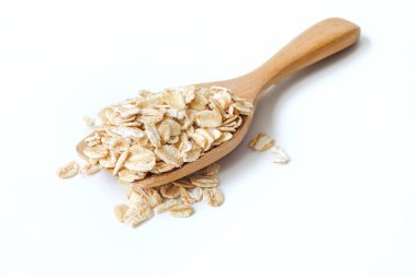 Tahta kaşıkta yulaf ezmesi. Beyaz arka planda kapanıyor..