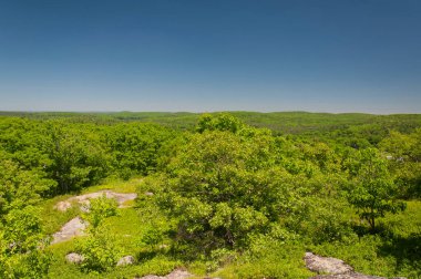 A landscape view from atop stone man mountain on the iron trail in Falls Village Caanan connecticut on cloudless summer day.