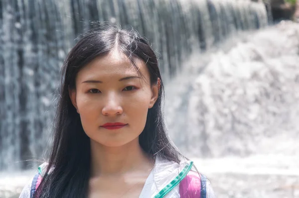 Chinese Woman Stern Look Her Face Blurred Waterfall Background Rural — Φωτογραφία Αρχείου