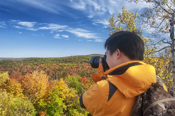 stock image A Chinese man photographing the autumn colors at the Becket Quarry Land Trust in Massachusetts.